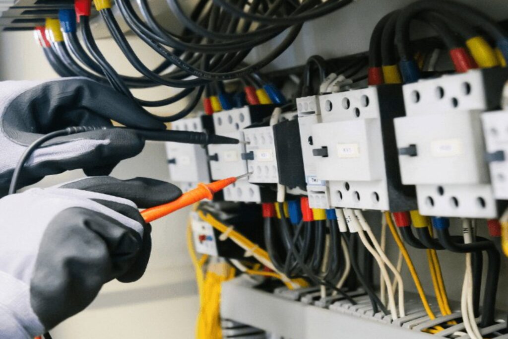 Electrician testing an electrical panel with a multimeter - Google Business Profile categories for electricians