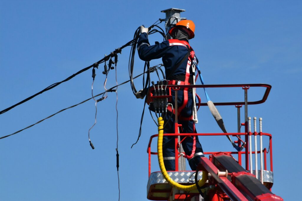 Utility lineman working on overhead power lines - Google reviews for electricians