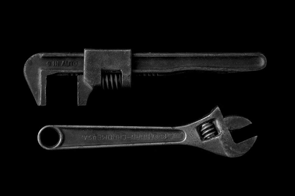 Pipe wrenches and hand tools used for plumbing repair work