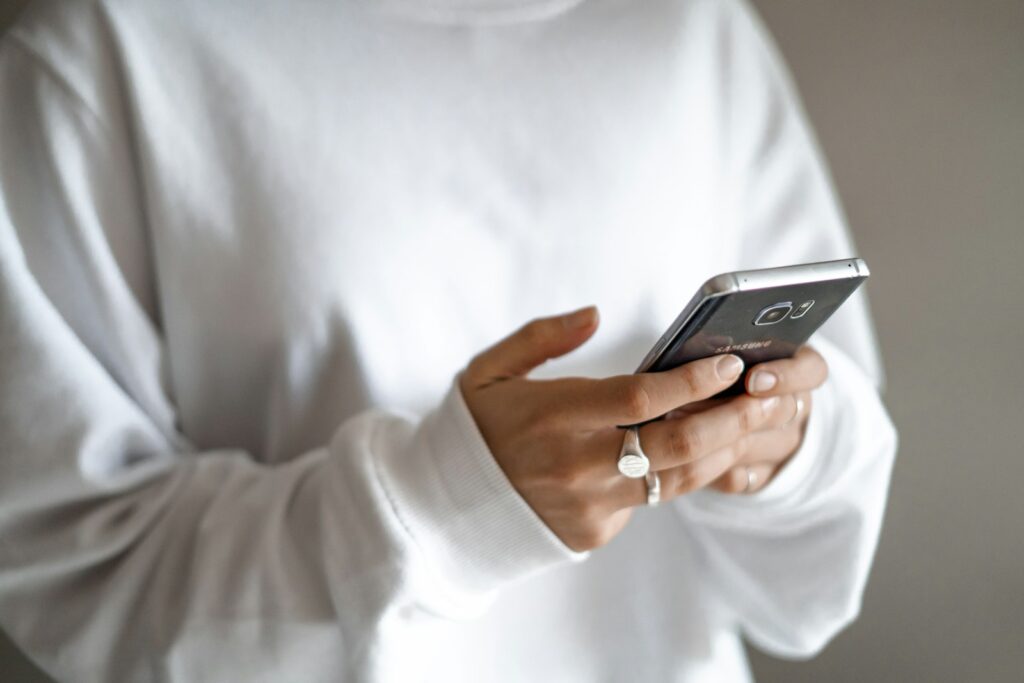 Person typing a response on a smartphone, representing replying to a Google review