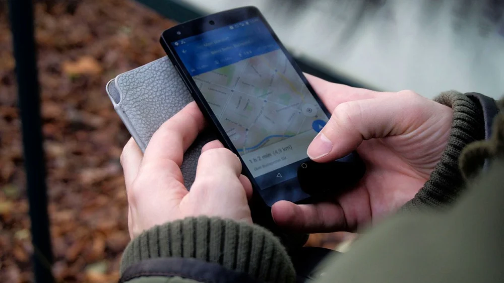 Person using a smartphone to look at a map, the way a customer searches for a local business