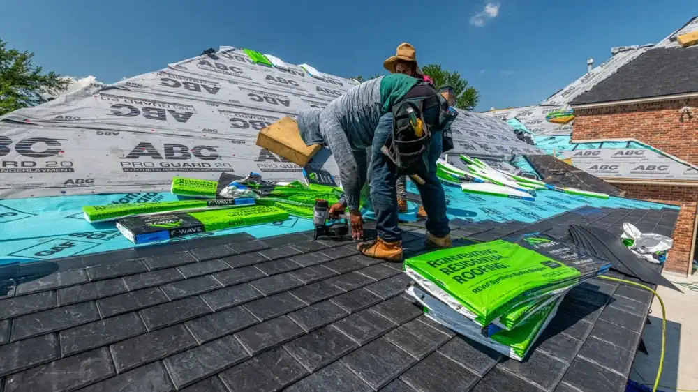 Roofers installing shingles on a residential roof